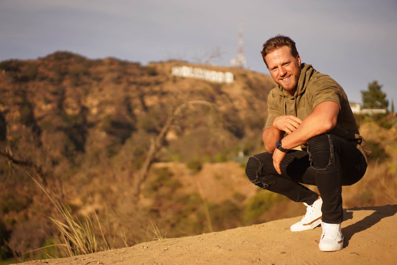 Alec Penix in Los Angeles with Hollywood sign